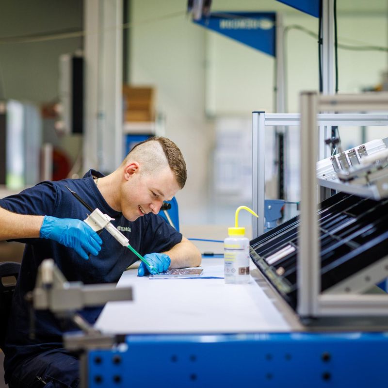 male_technician_manufacturing_laughing_covered_hands